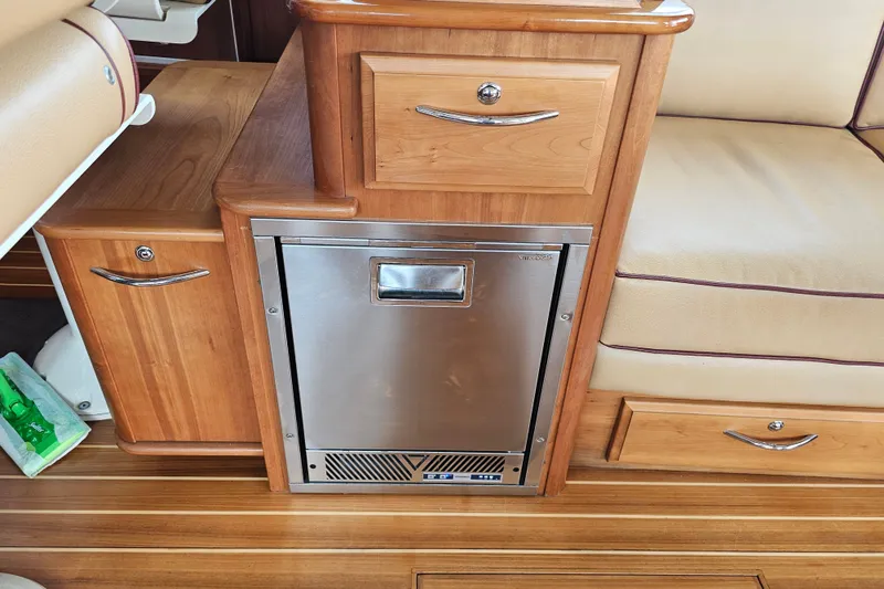 Slide: The Image of Wooden interior of 2013 Sabre 48 Salon Express with built-in stainless steel fridge. - 15