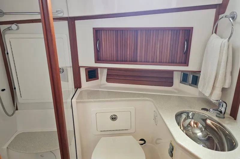 Slide: The Image of Bathroom interior of 2013 Sabre 48 Salon Express yacht, featuring sink and shower. - 50