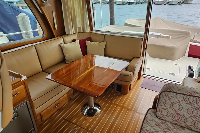 Slide: The Image of Interior of 2013 Sabre 48 Salon Express with wooden table and beige seating. - 11