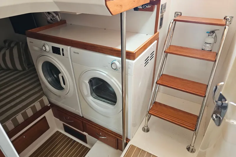 Slide: The Image of Laundry area with washer and dryer in 2013 Sabre 48 Salon Express yacht. - 54
