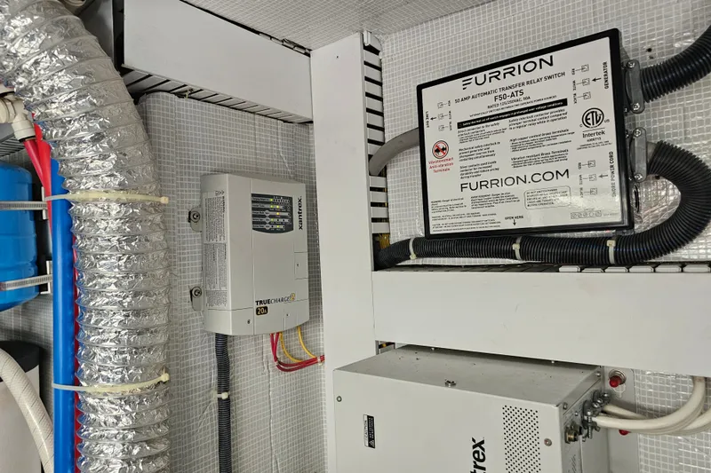 Slide: The Image of Electrical components in a 2013 Sabre 48 Salon Express, featuring Furrion and Xantrex systems. - 63