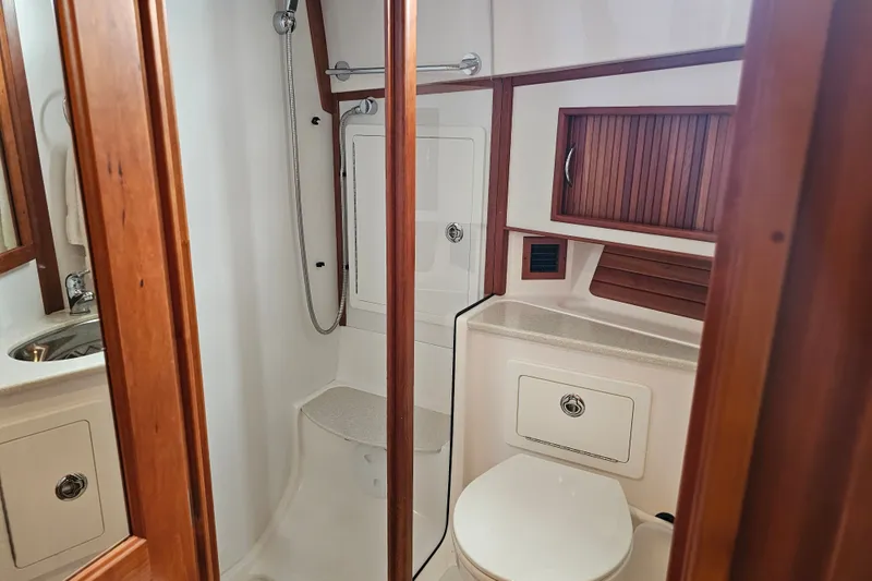 Slide: The Image of Bathroom interior of 2013 Sabre 48 Salon Express yacht, featuring wood accents and modern fixtures. - 49
