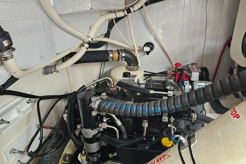 Slide: The Image of Engine room of a 2013 Sabre 48 Salon Express with visible hoses and components. - 61