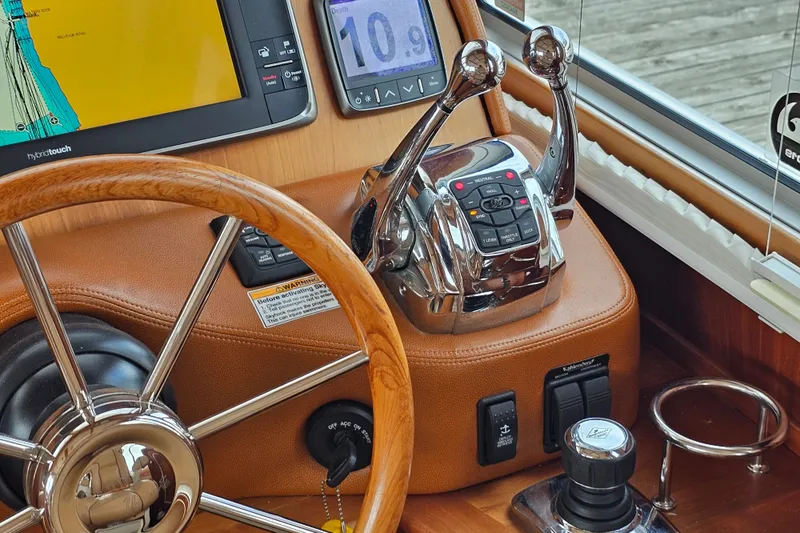 Slide: The Image of Steering wheel and controls of 2013 Sabre 48 Salon Express yacht cockpit. - 24