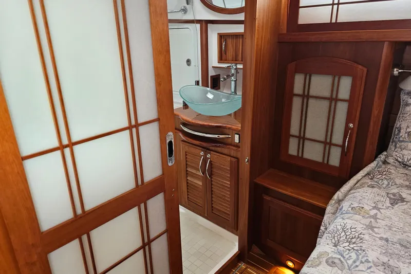 Slide: The Image of Interior of 2013 Sabre 48 Salon Express with elegant wood finish and modern glass sink. - 37