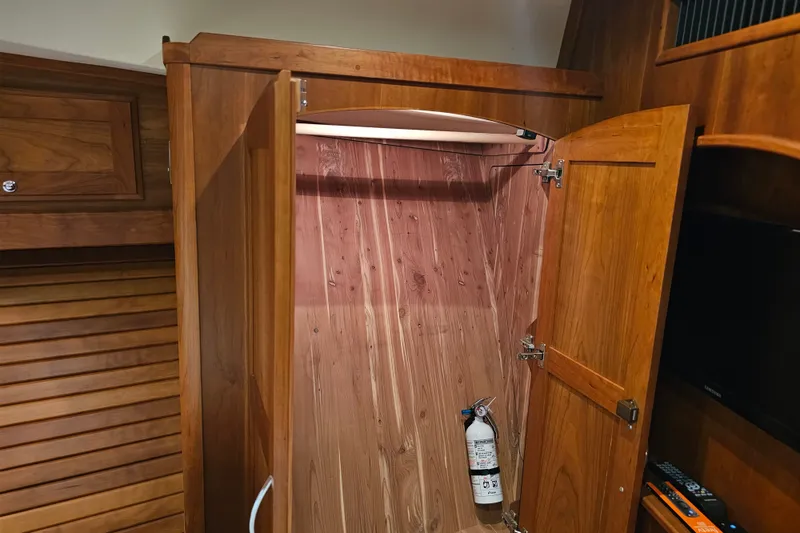 Slide: The Image of Wooden closet interior with fire extinguisher on a 2013 Sabre 48 Salon Express yacht. - 44