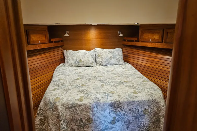 Slide: The Image of Cozy bedroom in 2013 Sabre 48 Salon Express yacht with wooden accents and patterned bedding. - 40