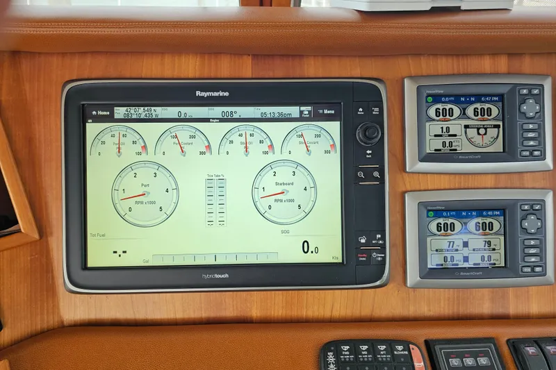 Slide: The Image of Control panel of a 2013 Sabre 48 Salon Express with Raymarine and SmartCraft displays. - 20