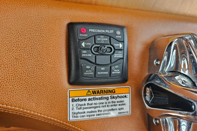 Slide: The Image of Control panel of a 2013 Sabre 48 Salon Express with Skyhook feature and warning label. - 25