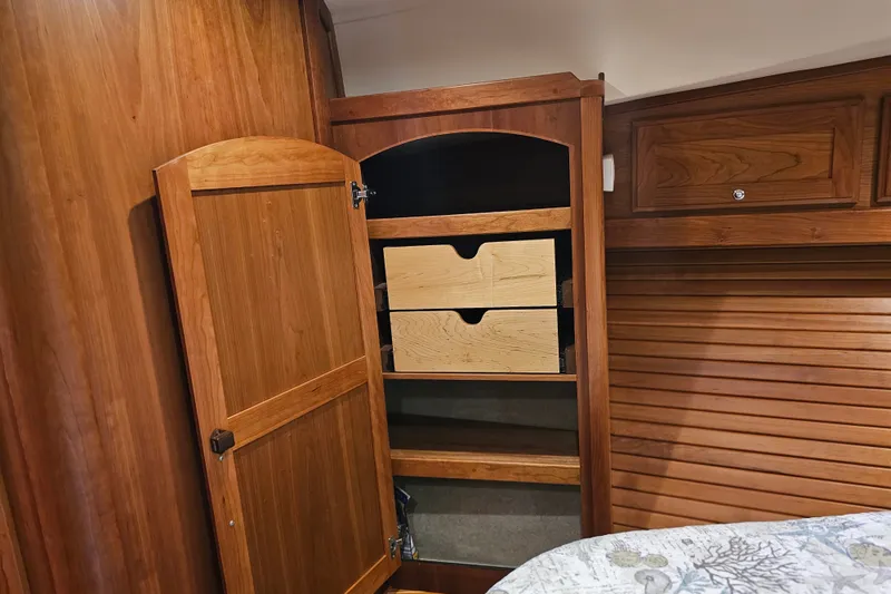 Slide: The Image of Wooden cabinet interior on 2013 Sabre 48 Salon Express yacht, featuring open shelves and drawers. - 48