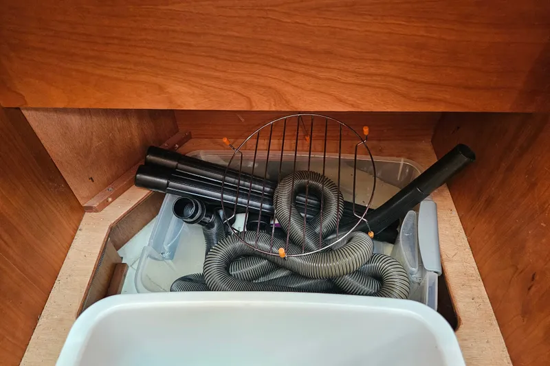 Slide: The Image of Storage compartment in a 2013 Sabre 48 Salon Express with hoses and accessories. - 31