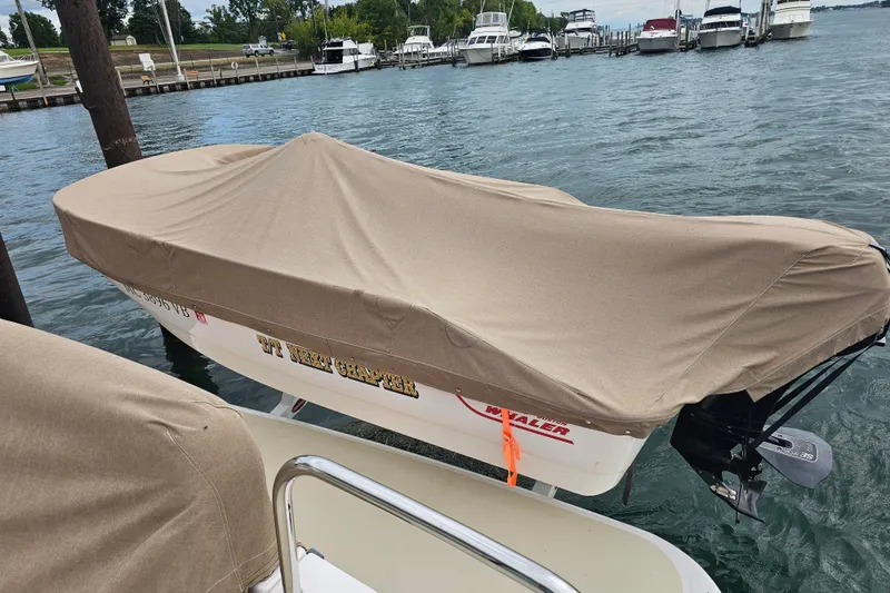 Slide: The Image of Covered boat docked at marina, featuring a Sabre 48 Salon Express, 2013 model. - 9
