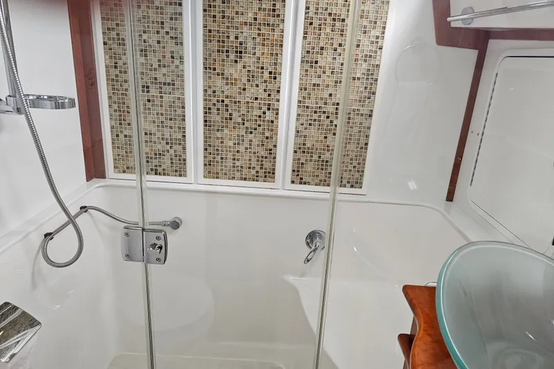 Slide: The Image of Luxurious bathroom in 2013 Sabre 48 Salon Express yacht with glass sink and mosaic tiles. - 39