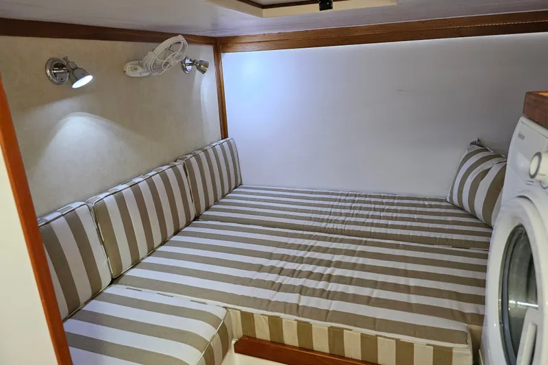Slide: The Image of Cozy interior of 2013 Sabre 48 Salon Express with striped cushions and washing machine. - 52