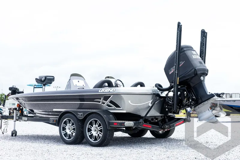 Slide: The Image of 2015 Legend V-20 boat on trailer, featuring sleek design and powerful outboard motor. - 7