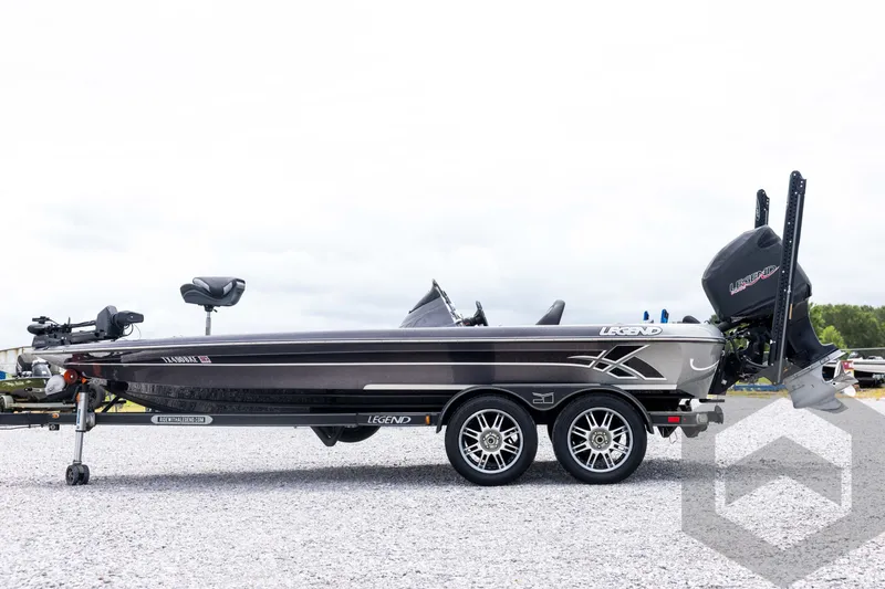 Slide: The Image of 2015 Legend V-20 boat on trailer, side view, parked on gravel. - 8