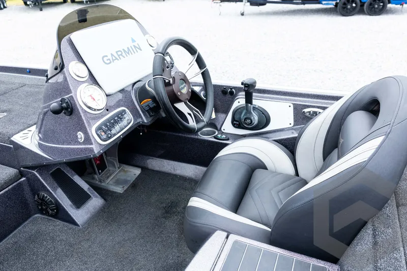 Slide: The Image of Interior of a 2015 Legend V-20 boat with Garmin navigation system and plush seating. - 28