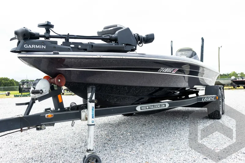 Slide: The Image of 2015 Legend V-20 boat with Garmin equipment on a trailer in a gravel lot. - 14
