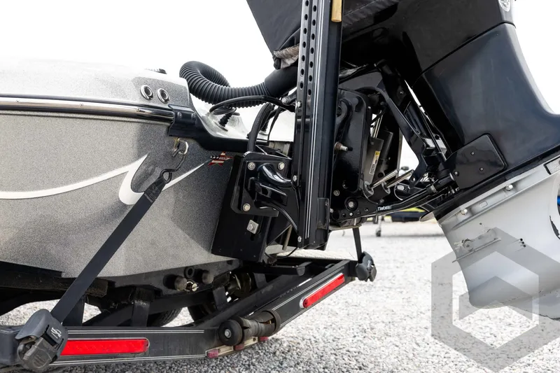 Slide: The Image of Close-up of a 2015 Legend V-20 boat motor and trailer on gravel. - 12