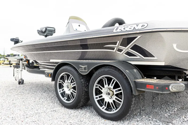 Slide: The Image of 2015 Legend V-20 boat on trailer, showcasing sleek design and modern wheels. - 13