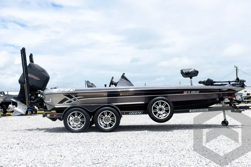 Slide: The Image of 2015 Legend V-20 boat on trailer, sleek design, dual axles, outdoor setting. - 4