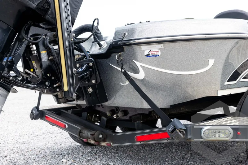 Slide: The Image of Close-up of a 2015 Legend V-20 boat trailer hitch and motor components. - 11