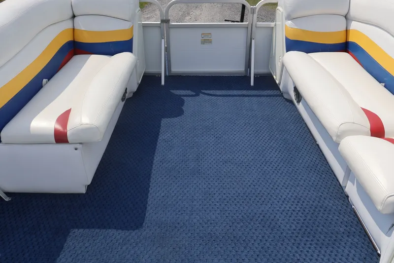Slide: The Image of Interior of 2007 Manitou 22 Oasis boat with blue carpet and colorful seating. - 61