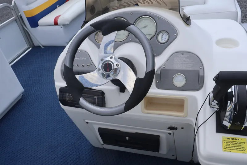 Slide: The Image of Steering console of a 2007 Manitou 22 Oasis boat with gauges and controls. - 47