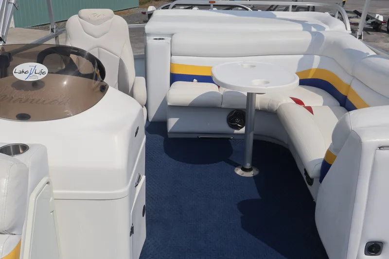 Slide: The Image of Interior of 2007 Manitou 22 Oasis boat with white seating and blue carpet. - 64