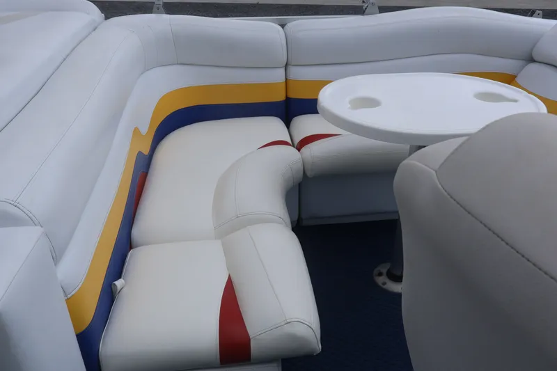 Slide: The Image of 2007 Manitou 22 Oasis boat interior with colorful seating and a round table. - 36