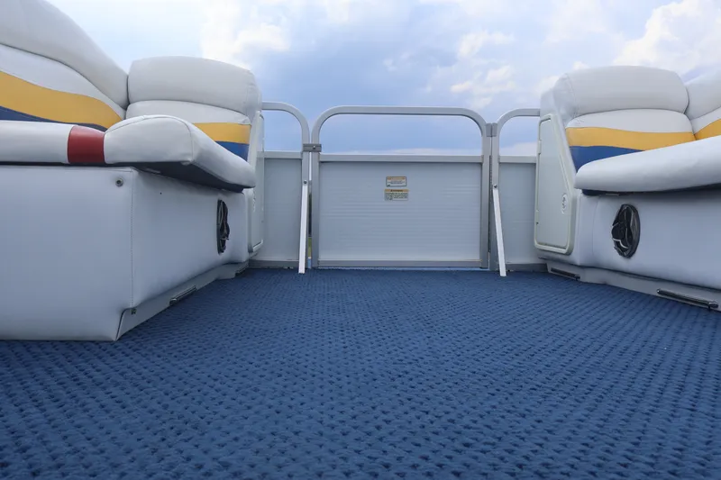Slide: The Image of Interior of a 2007 Manitou 22 Oasis pontoon boat with blue carpet and cushioned seating. - 43