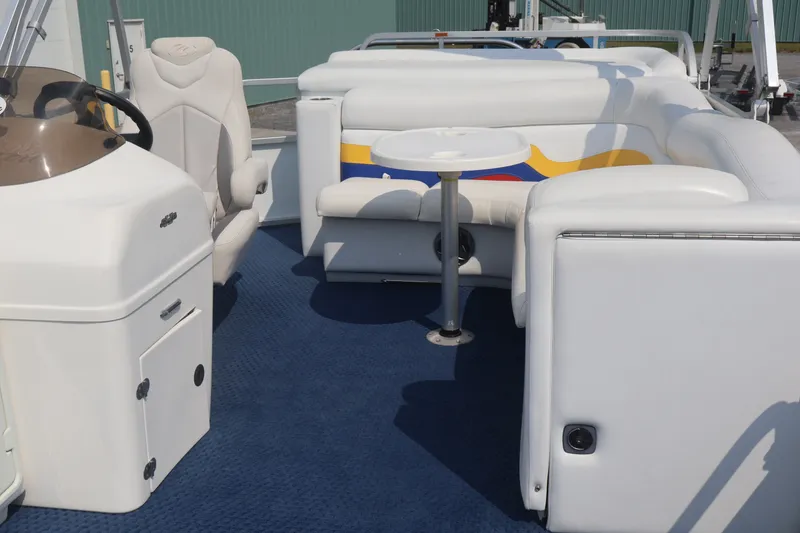 Slide: The Image of Interior of a 2007 Manitou 22 Oasis pontoon boat with white seating and blue carpet. - 67