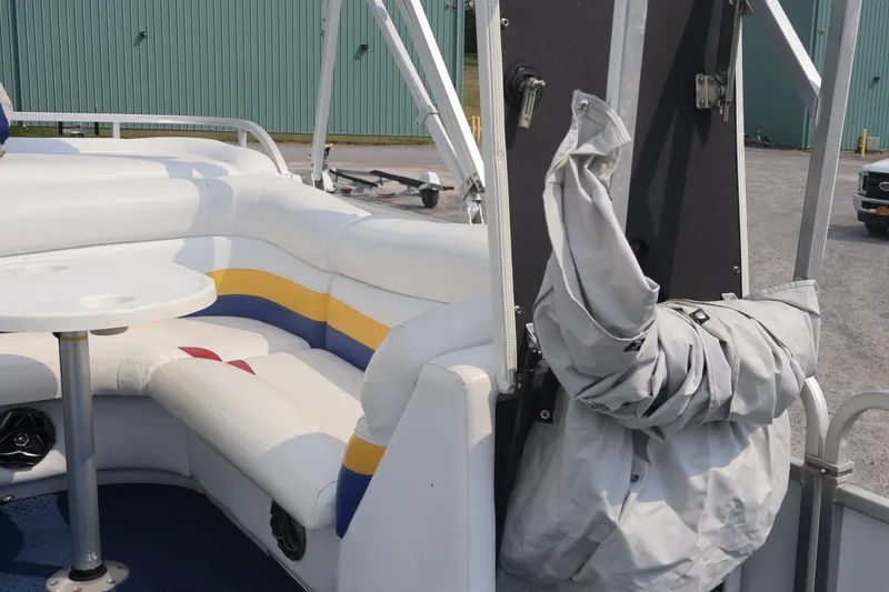 Slide: The Image of 2007 Manitou 22 Oasis pontoon boat interior with white seating and table. - 58