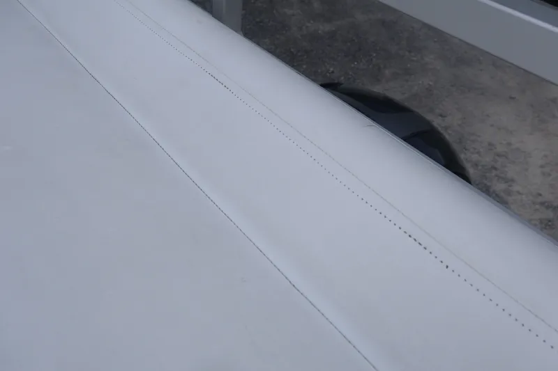 Slide: The Image of Close-up of a 2007 Manitou 22 Oasis boat surface with visible stitching. - 33
