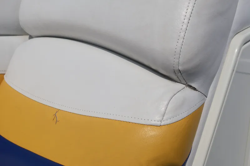 Slide: The Image of Close-up of 2007 Manitou 22 Oasis boat seat with white and yellow upholstery. - 65