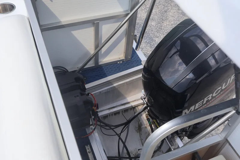 Slide: The Image of 2007 Manitou 22 Oasis boat engine compartment with Mercury outboard motor. - 29