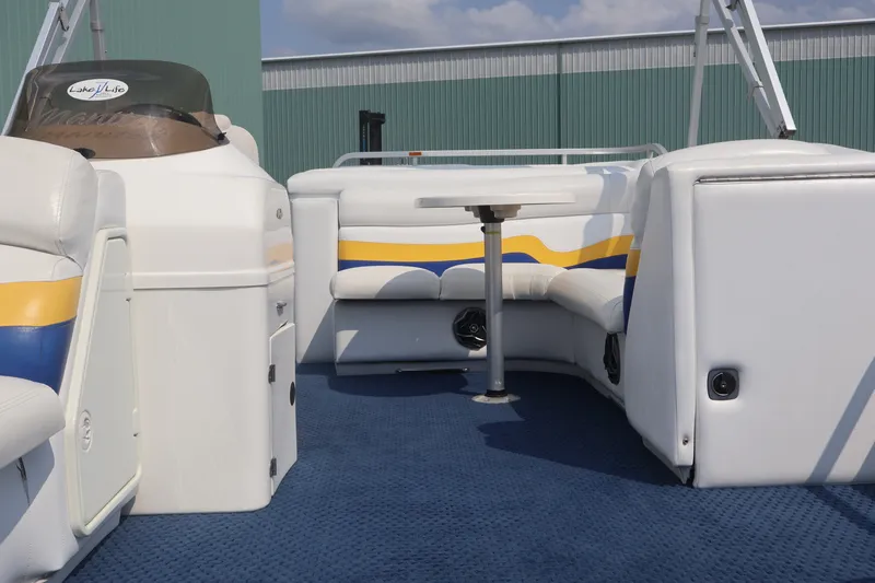 Slide: The Image of 2007 Manitou 22 Oasis pontoon boat interior with blue carpet and white seating. - 63