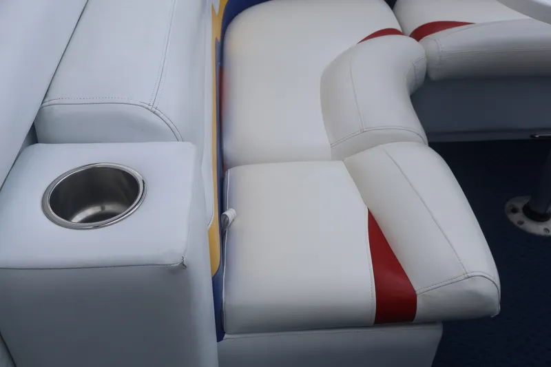 Slide: The Image of 2007 Manitou 22 Oasis boat interior with white and red seating, featuring a built-in cup holder. - 35