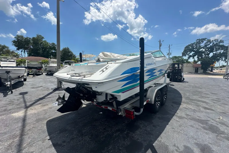Slide: The Image of 2000 Formula 271 FASTech boat on trailer under clear blue sky. - 4