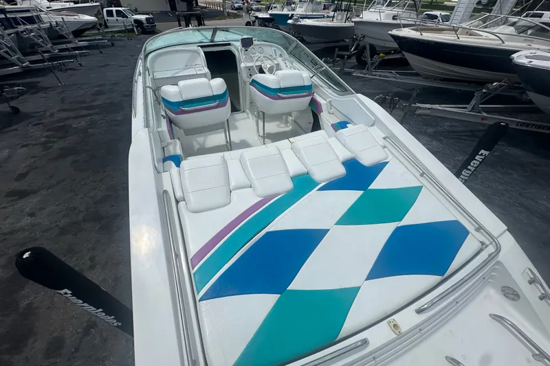 Slide: The Image of 2000 Formula 271 FASTech boat with colorful seating and geometric design, docked among other boats. - 9