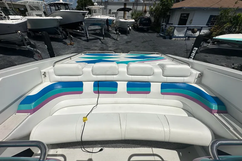Slide: The Image of 2000 Formula 271 FASTech boat interior with colorful seating in a marina setting. - 10