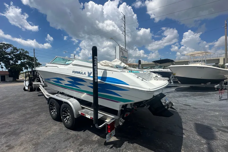 Slide: The Image of 2000 Formula 271 FASTech boat on trailer under a cloudy sky. - 2