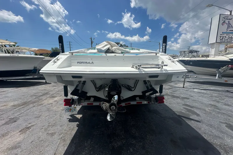 Slide: The Image of 2000 Formula 271 FASTech boat rear view in a marina under a blue sky. - 3