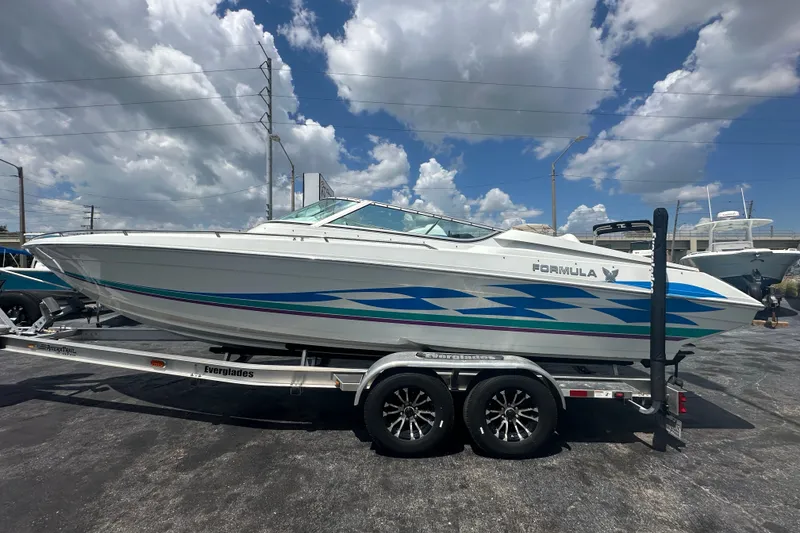 Slide: The Image of 2000 Formula 271 FASTech boat on trailer under cloudy sky. - 1
