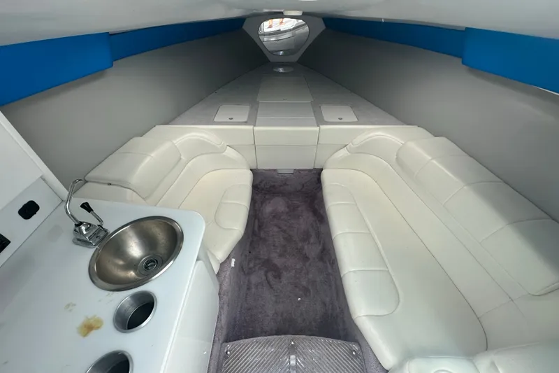 Slide: The Image of Interior of a 2000 Formula 271 FASTech boat with white seating and a small sink. - 14