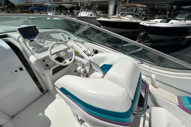 Slide: The Image of Cockpit of 2000 Formula 271 FASTech boat with white and teal seating. - 12