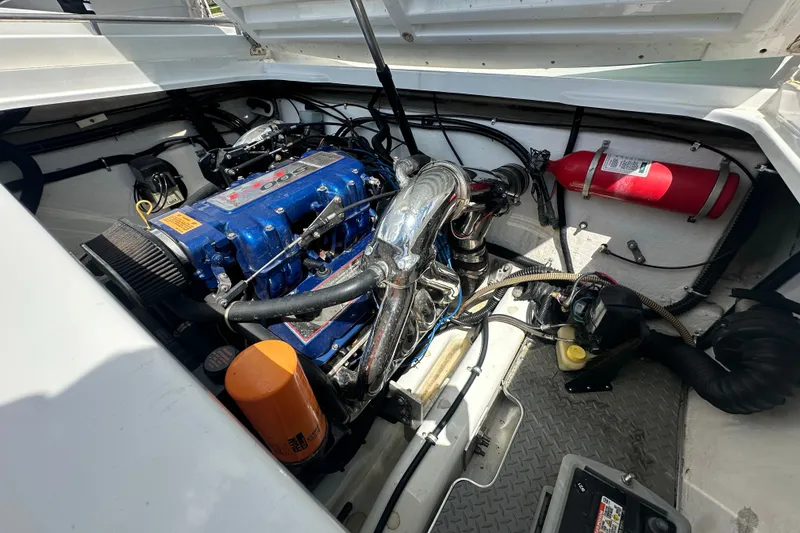 Slide: The Image of Engine compartment of a 2000 Formula 271 FASTech boat, featuring a blue engine and fire extinguisher. - 17