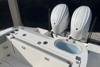 Slide: The Image of 2024 Cobia 262 Center Console boat with dual engines and livewell. - 13