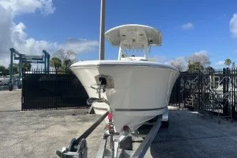 Slide: The Image of 2024 Cobia 262 Center Console boat on trailer under clear blue sky. - 3