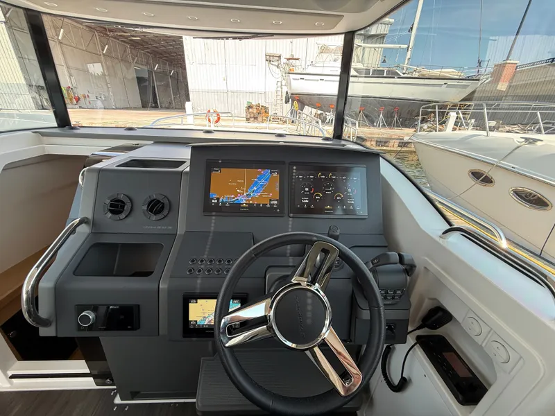 Slide: The Image of The image shows the cockpit of a 2024 Nimbus Commuter 11 with modern navigation systems. - 18
